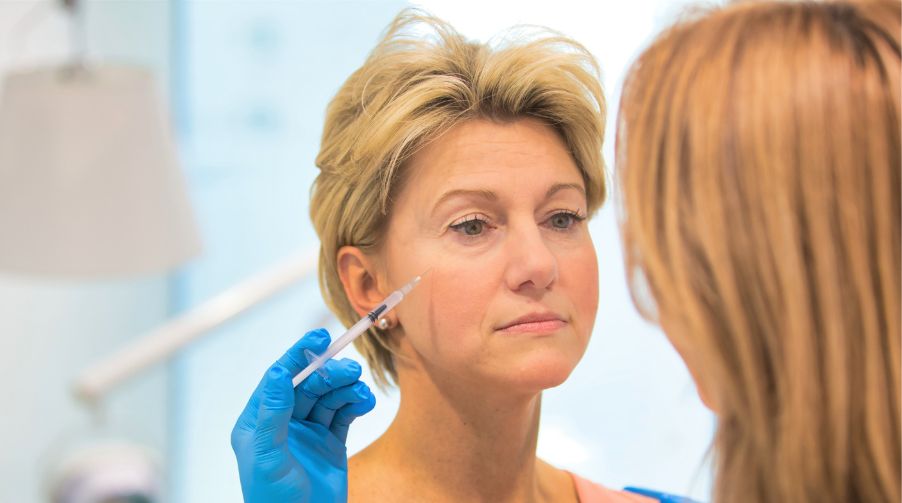 Licensed practitioner carefully injecting Botox into a patient’s face during a cosmetic procedure